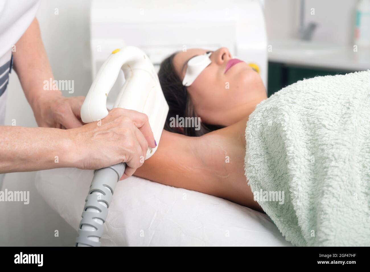 Laser epilation and cosmetology in beauty salon. Cosmetology, spa and hair removal concept. High quality photo. Stock Photo