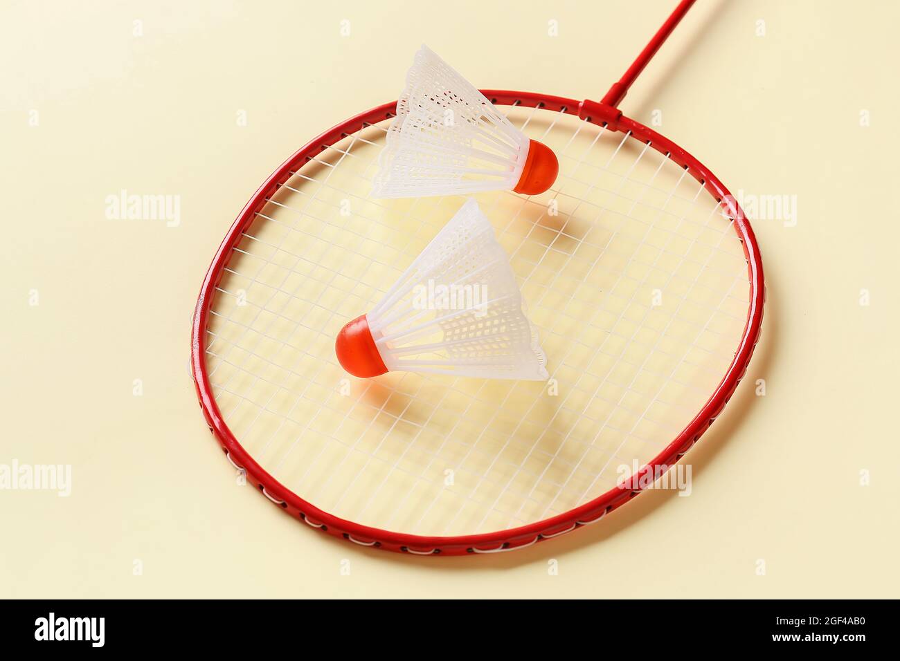 Badminton racket and shuttlecocks on color background Stock Photo