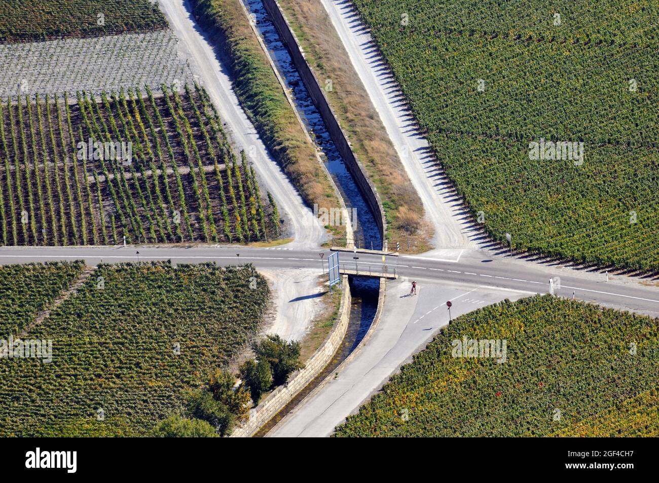 View for vineyards in autumn - October, Bisse - irrigation ditch with water along the roadway, Bisses, only found in the Valais region of Stock Photo