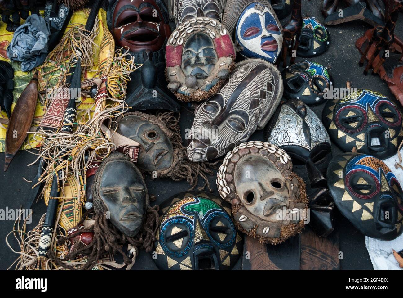 Shopping in the street markets of Banjul. Masks and other wood carvings.  Banjul, The Gambia, Africa Stock Photo - Alamy