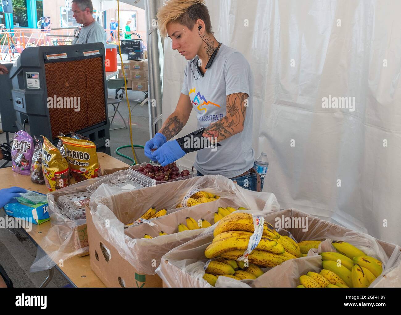 August 22, 2021: Race volunteers prepare food and hydration for mountain runners prior to the Pikes Peak Marathon, Manitou Springs, Colorado. Stock Photo