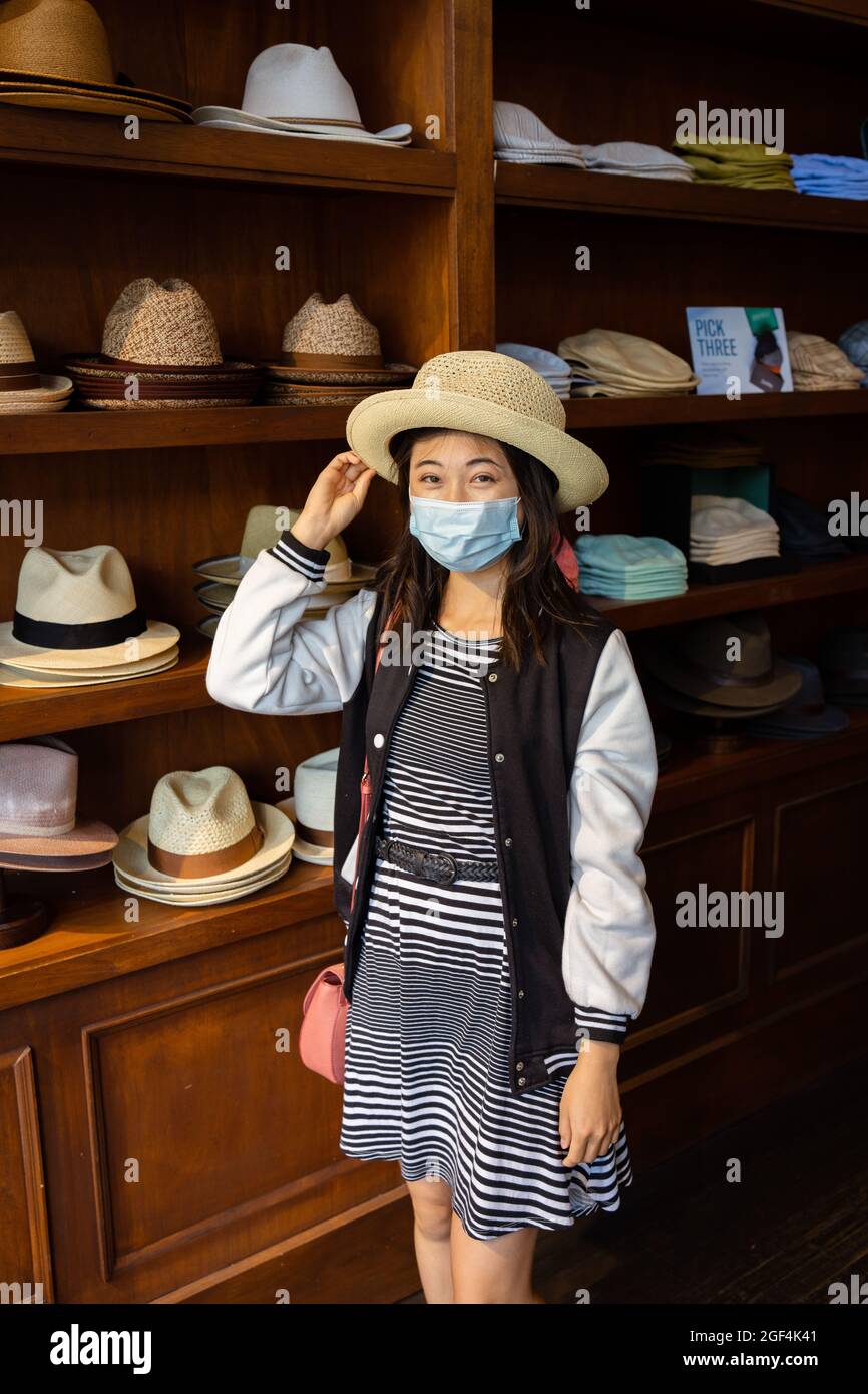 Beautiful young asian woman shopping for hats in San Francisco Stock Photo