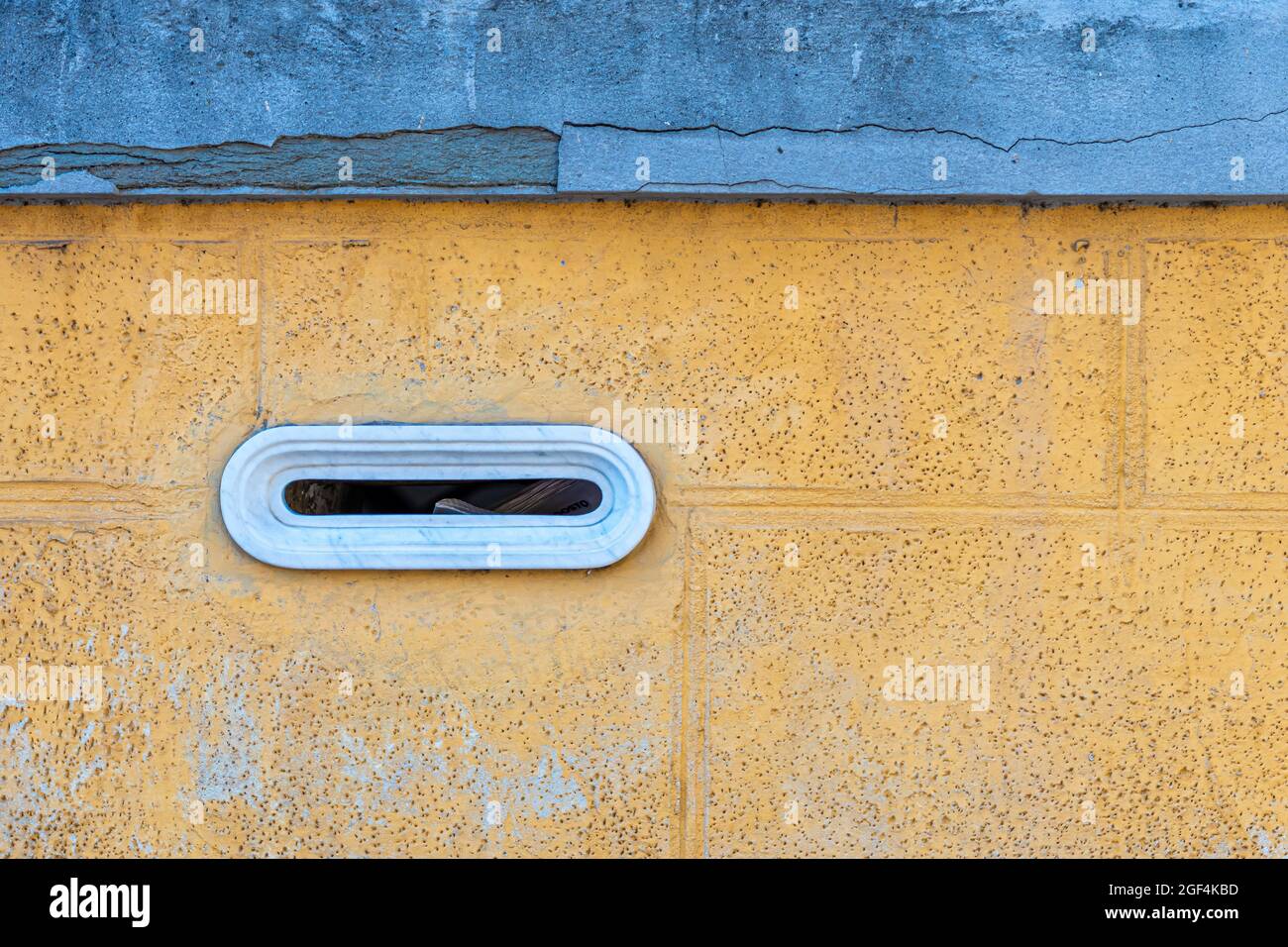 detail of an old letterbox on a brick wall, vintage marble built-in mailbox, Pisa, Italy Stock Photo