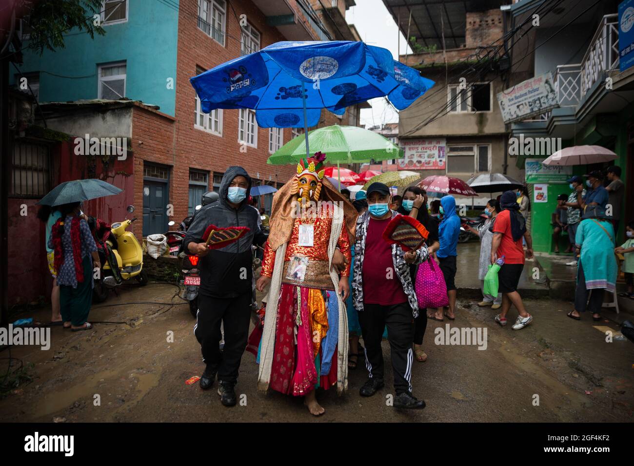Kathmandu, Nepal. 23rd Aug, 2021. A man dressed in a traditional costume performs during the festival.People celebrate Gai Jatra or cow festival in the memory of departed souls in the past year for salvation and peace. It is believed that cows guide the departed souls to cross the river to get to heaven. (Photo by Bivas Shrestha/SOPA Images/Sipa USA) Credit: Sipa USA/Alamy Live News Stock Photo