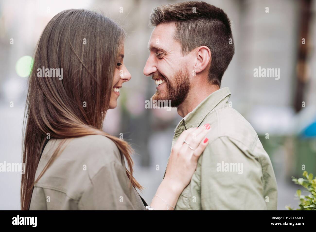 Man smiling while looking at girlfriend Stock Photo