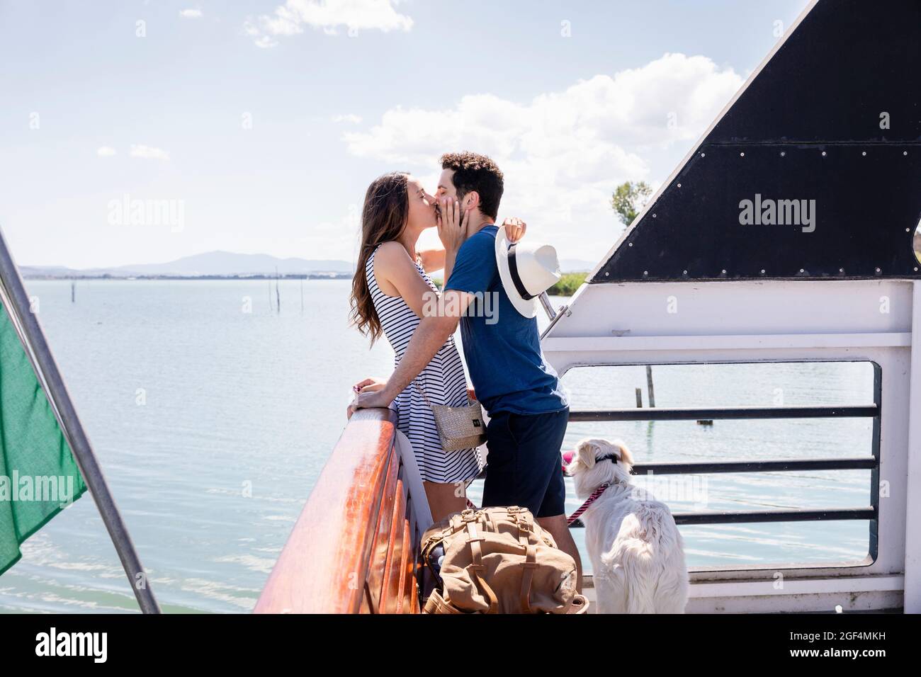 Couple kissing each other while standing at ferry boat Stock Photo