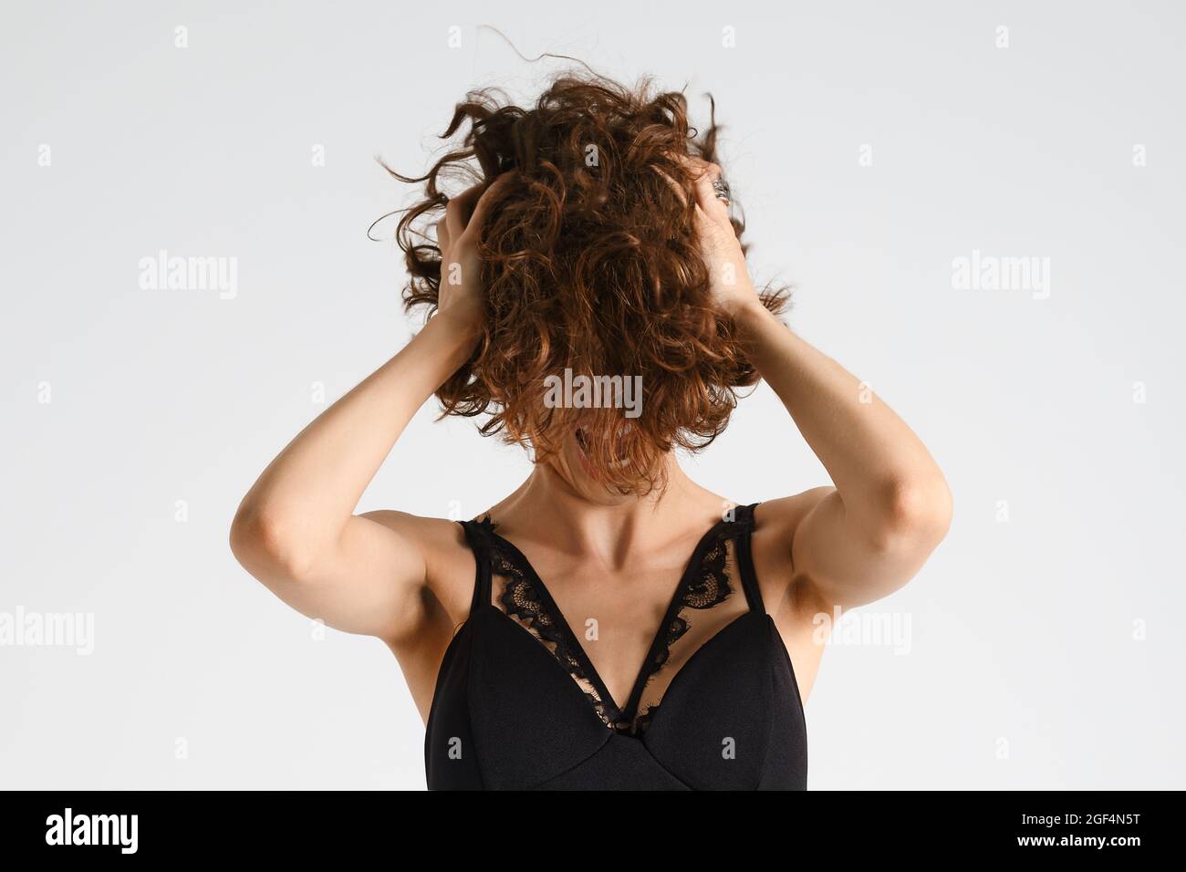 Emotional woman tears her short messy hair and screams in despair Stock Photo