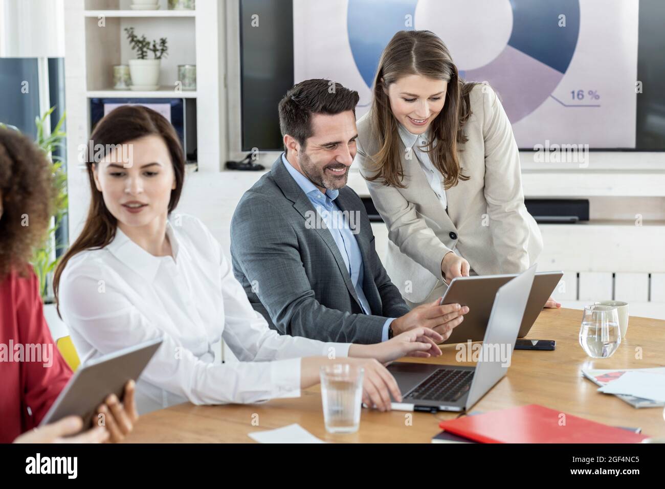 Professional team using digital tablet while working in meeting at office Stock Photo