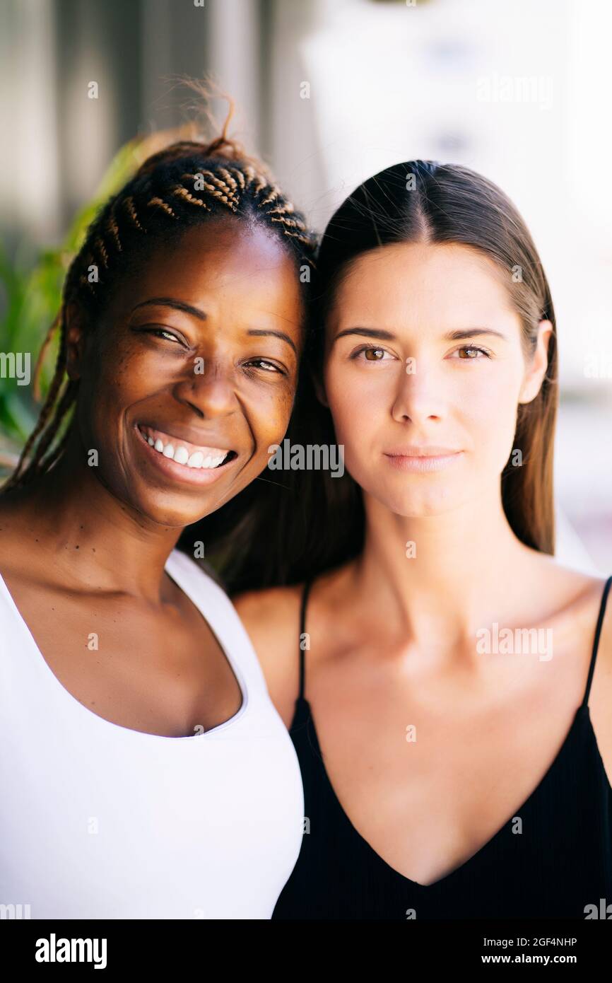 Smiling mature woman with young female friend Stock Photo