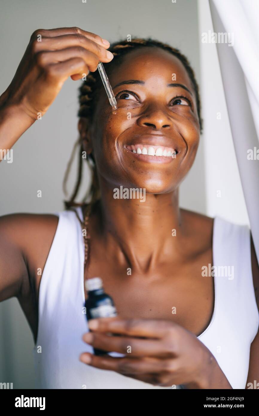 Woman serum face applying hi-res stock photography and images - Alamy