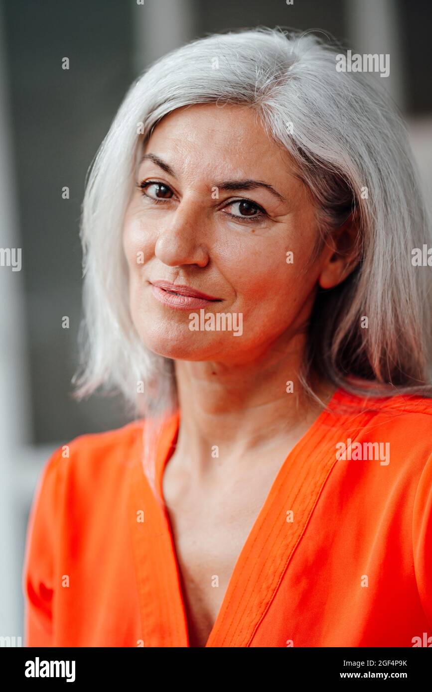 Mature businesswoman staring at office Stock Photo