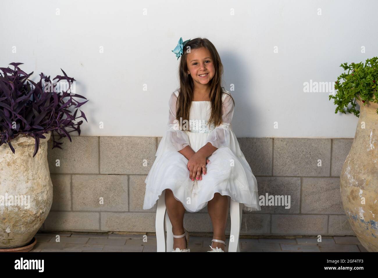 Closeup of a little girl sitting on the chair and smiling Stock Photo ...