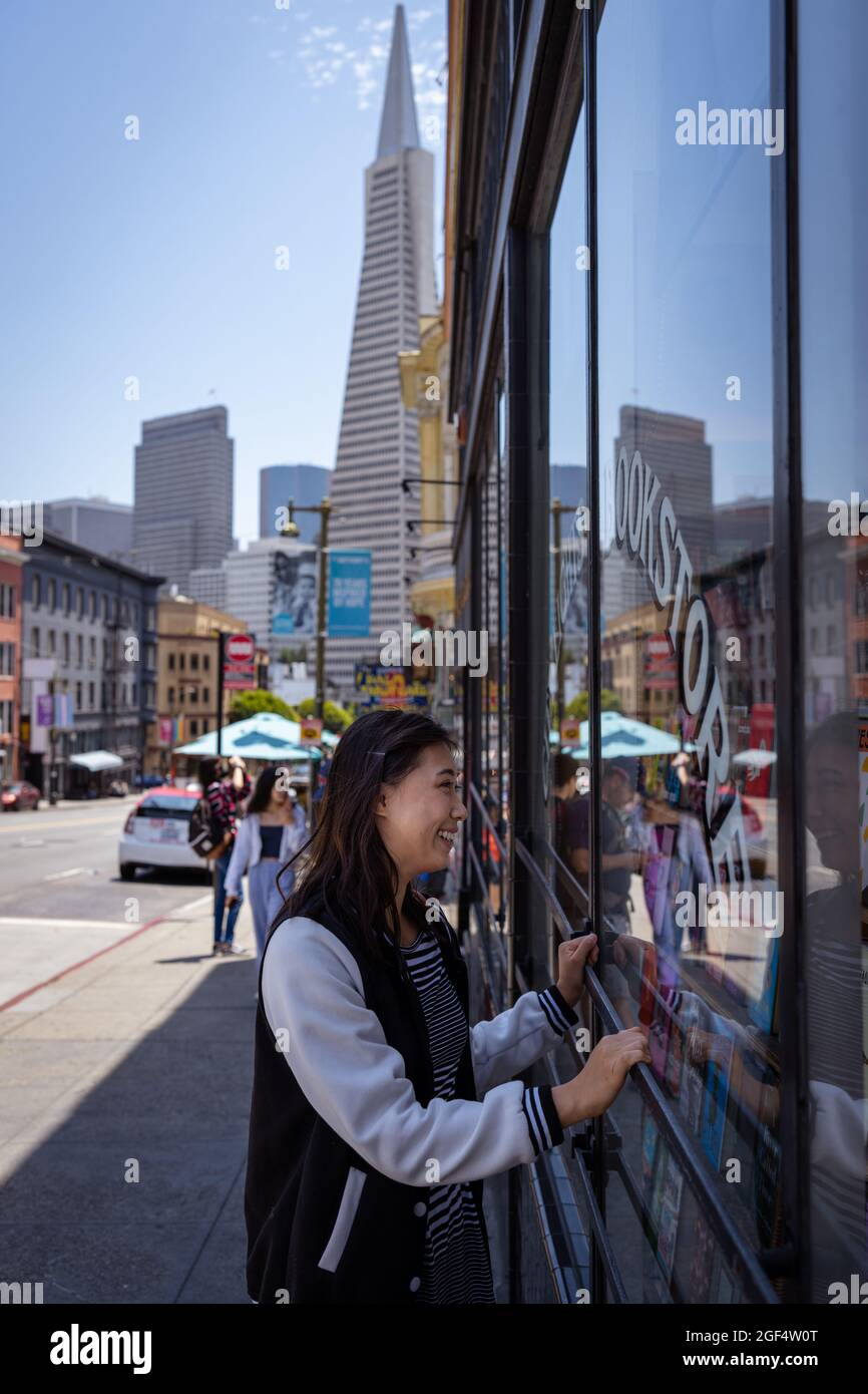 Beautiful Asian Woman Window Shopping for Books in San Francisco Stock Photo
