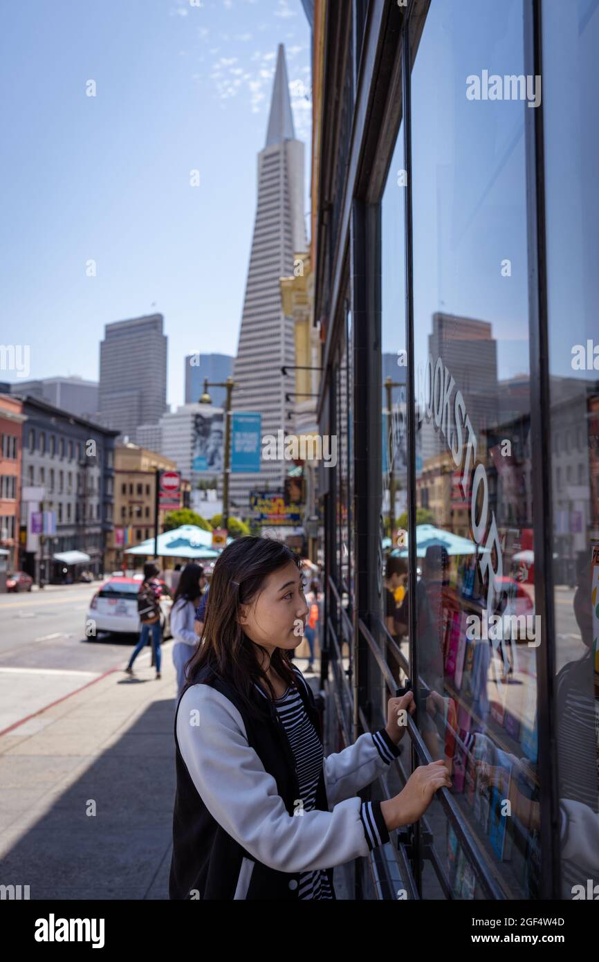 Beautiful Asian Woman Window Shopping for Books in San Francisco Stock Photo