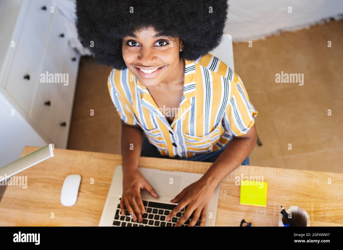 African american woman sitting desk hi-res stock photography and images ...