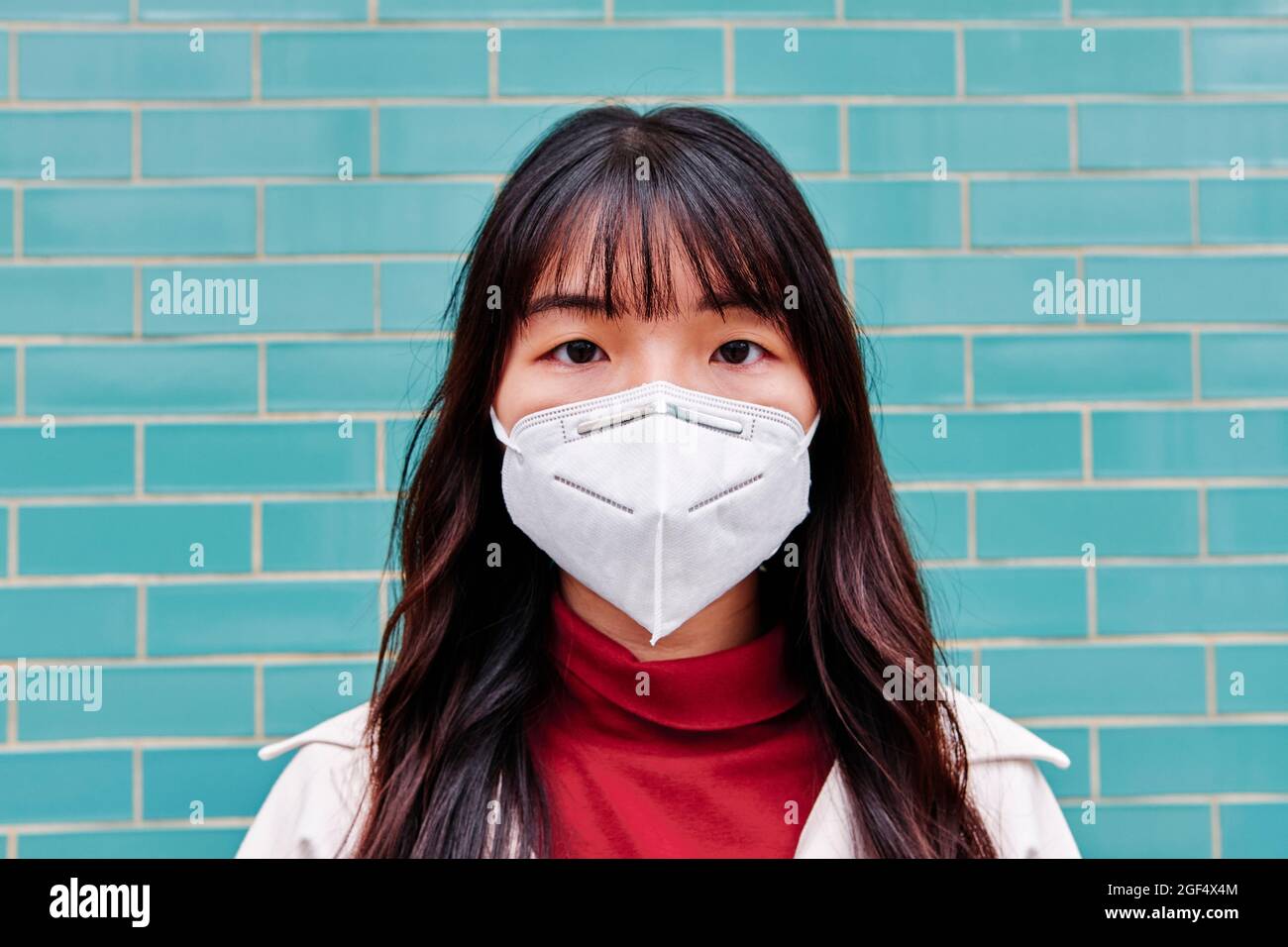 Young woman wearing protective face mask Stock Photo
