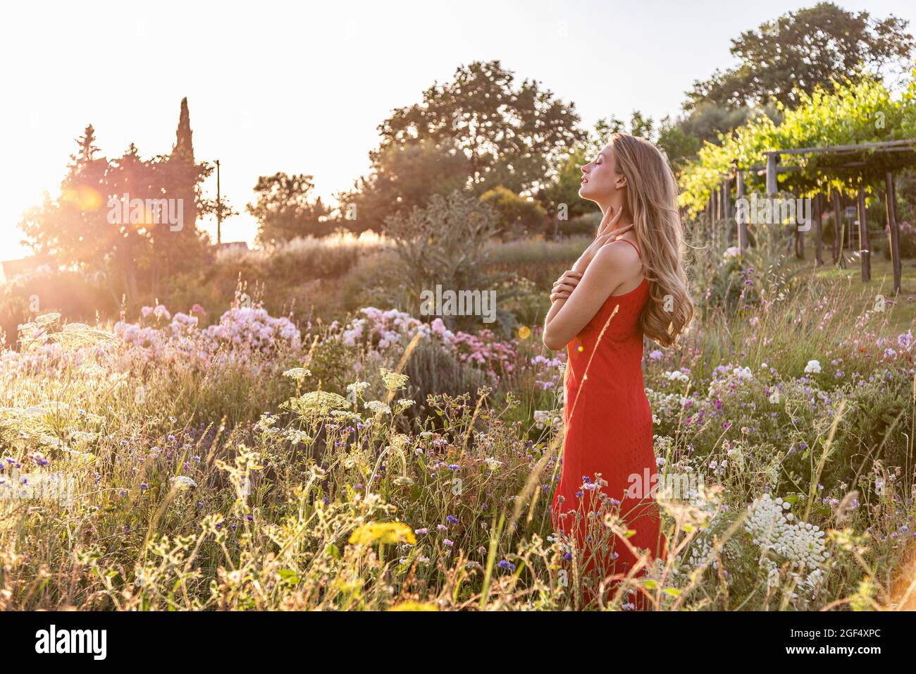 Young woman flowers standing hi-res stock photography and images - Alamy