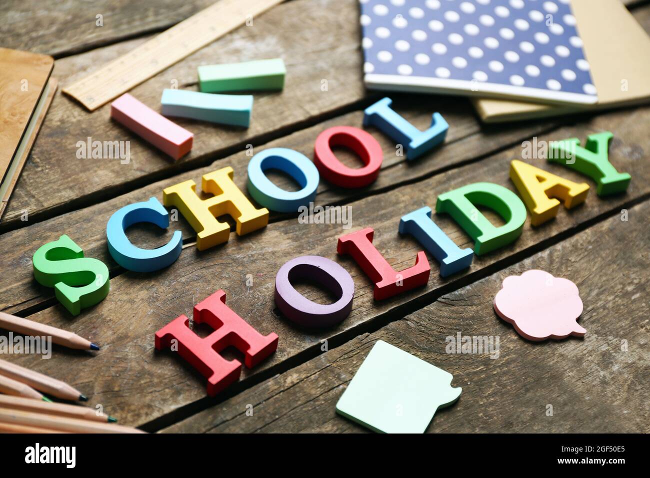 Set of stationery with alphabet on wooden table Stock Photo - Alamy