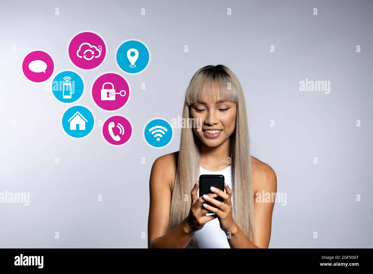 Blond woman using apps on smart phone over white background Stock Photo