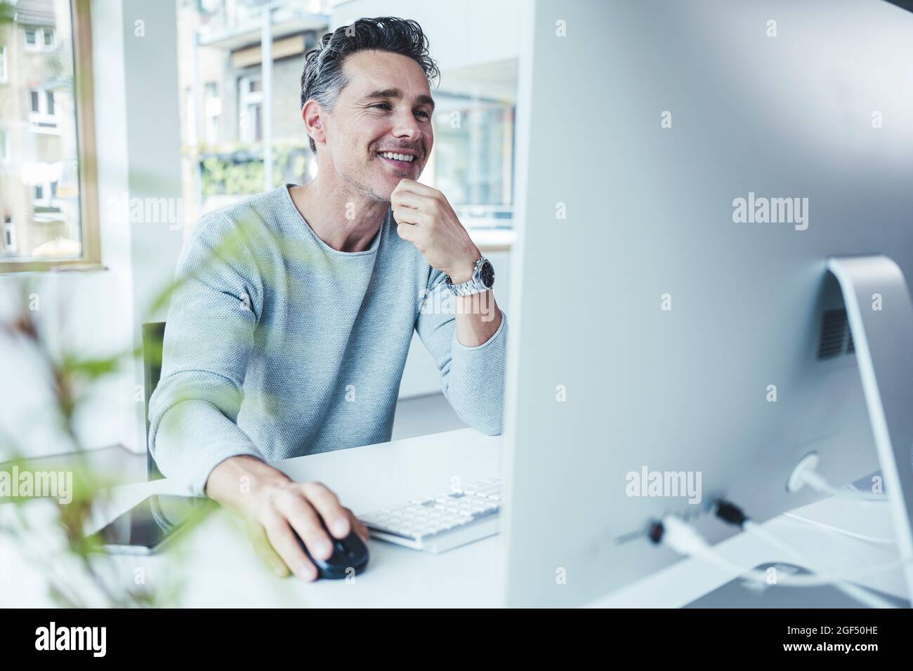 Mature businessman using office computer hi-res stock photography and ...