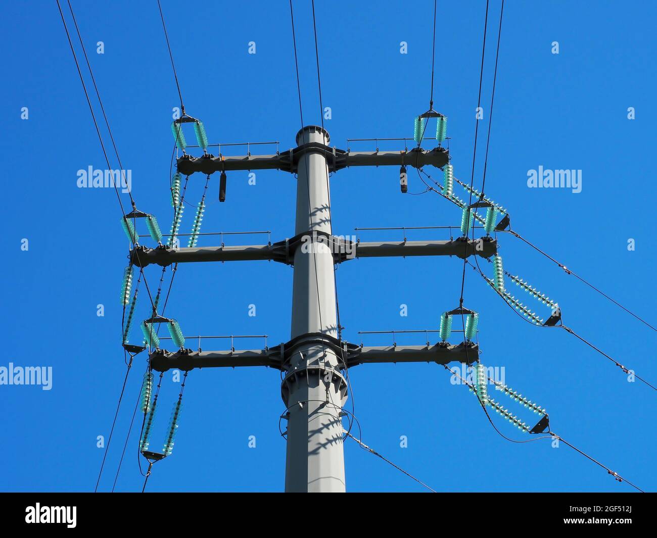 Electric pole with wires on blue sky background in sunlight Stock Photo ...