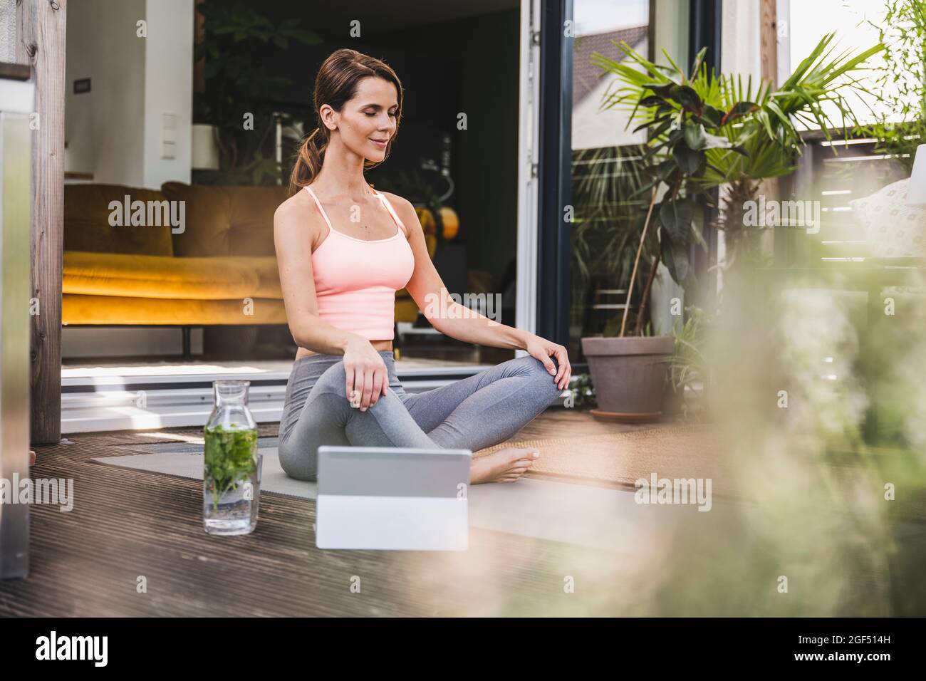 Woman practicing yoga on terrace Stock Photo