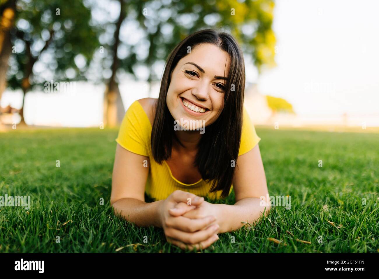 Young woman relaxing in park hi-res stock photography and images - Alamy