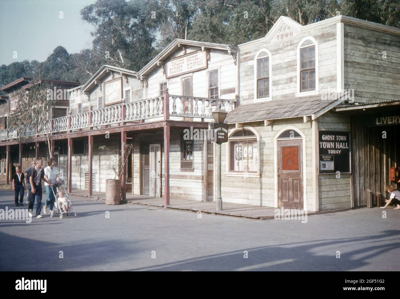 Knott's Berry Farm, Orange County, California. 1959. A young family walking past the Calico
