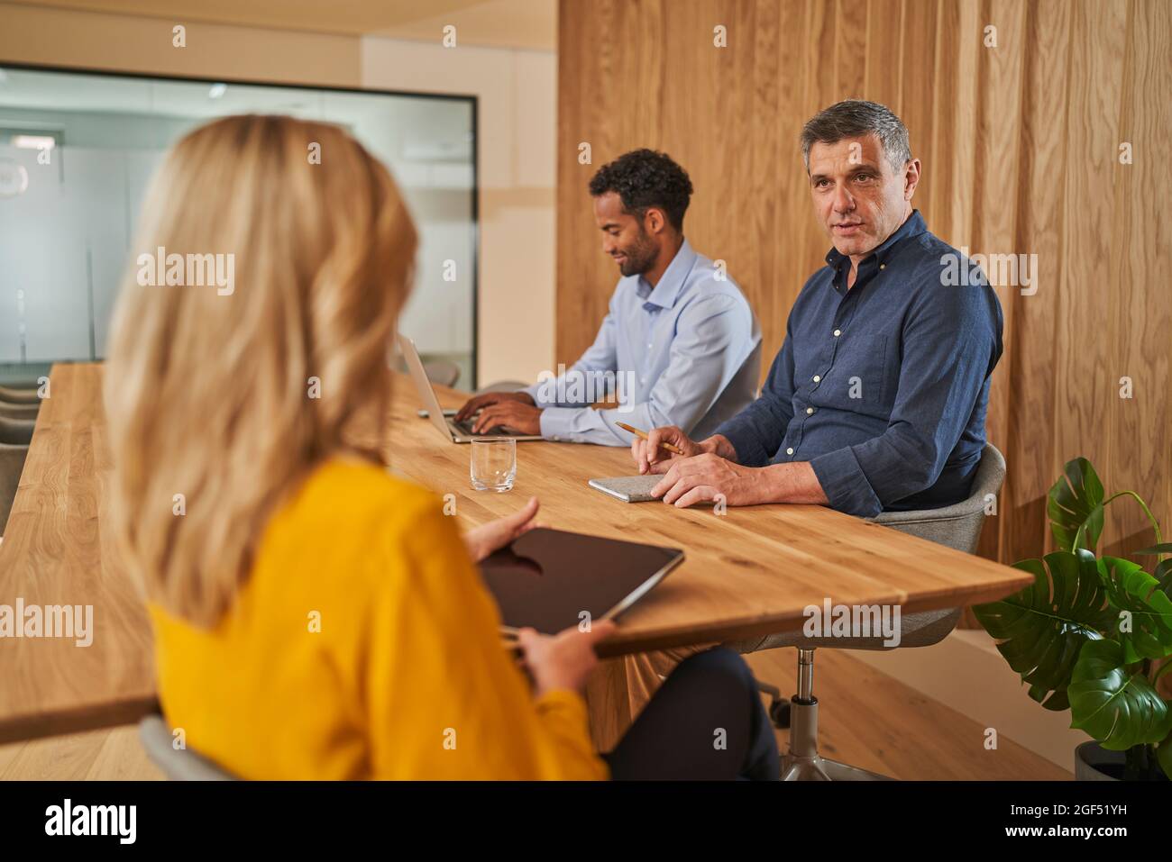Male and female colleagues discussing during meeting at office Stock Photo