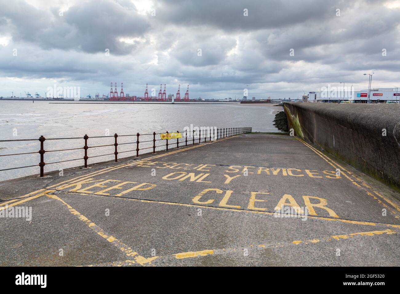 New Brighton, Wirral, UK: Slipway from the promenade to the beach for rescue services and keep clear warning Stock Photo