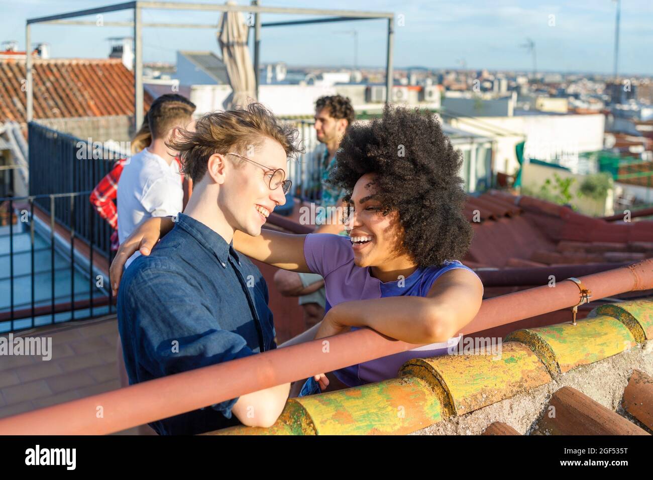 Cheerful multi-ethnic friends standing together on terrace Stock Photo