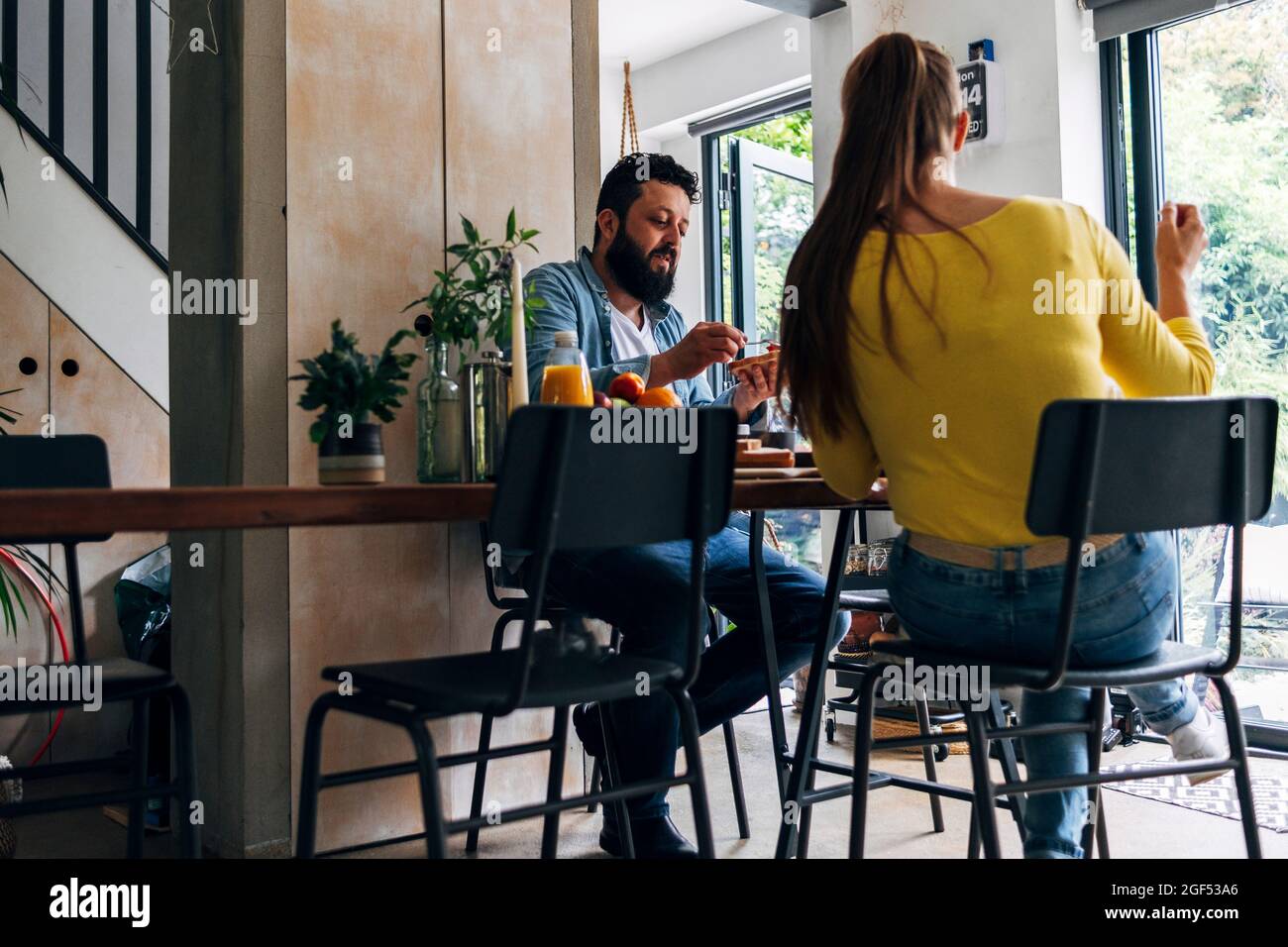 Woman sitting man rear table hi-res stock photography and images - Alamy