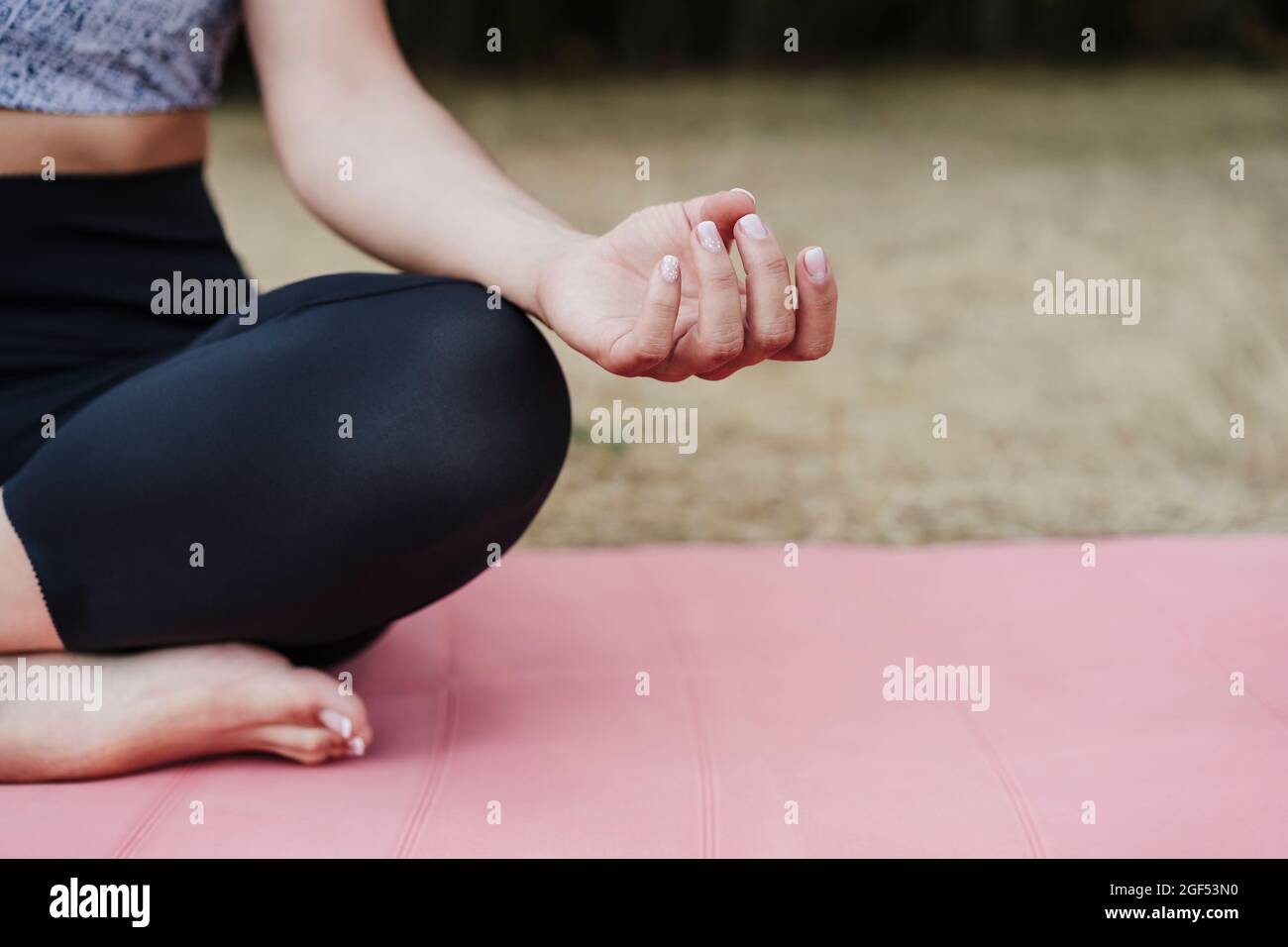 Sportswoman practicing lotus position at forest Stock Photo