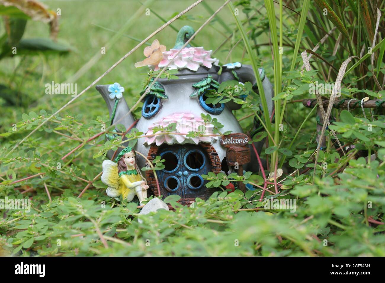 Fairy garden house in overgrown rock garden Stock Photo