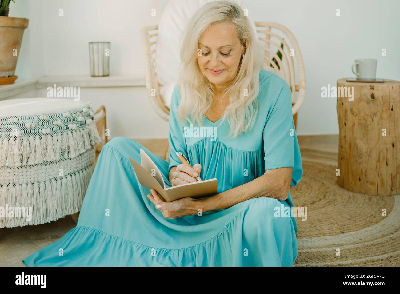 Blond woman sitting on stool hi-res stock photography and images - Alamy