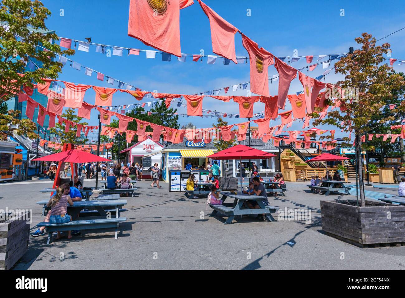 Halifax, Nova Scotia, Canada - 10 August 2021: Orange shirts hang at the Halifax waterfront to honour Indigenous children forcibly taken to residentia Stock Photo