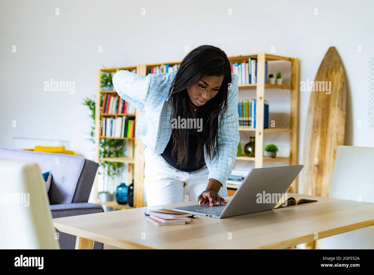 Pregnant female freelancer using laptop while working at home Stock Photo