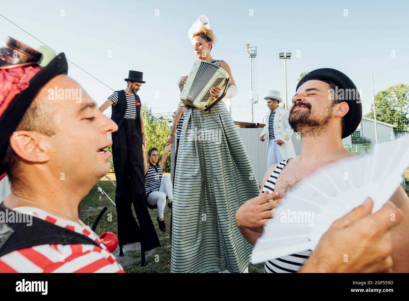 Male and female artist performing together on meadow Stock Photo - Alamy