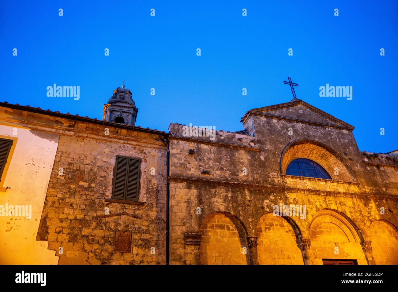 Italy, Province of Pisa, Pomarance, Old weathered walls of Church of San Giovanni Battista at dusk Stock Photo