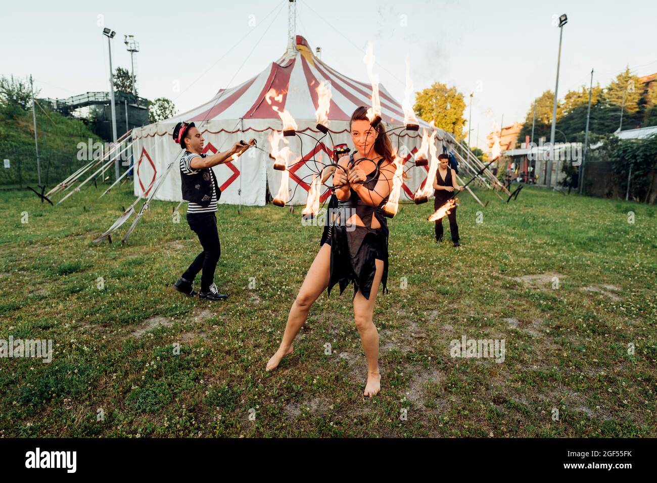 Male and female fire dancers practicing at circus Stock Photo Alamy