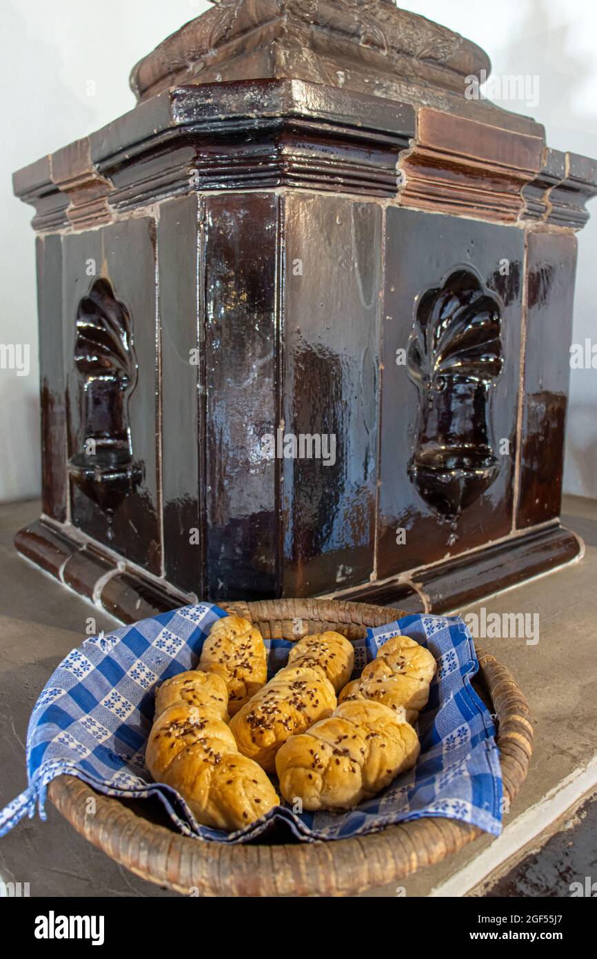 A pastries in a basket on an old tiled stove Stock Photo