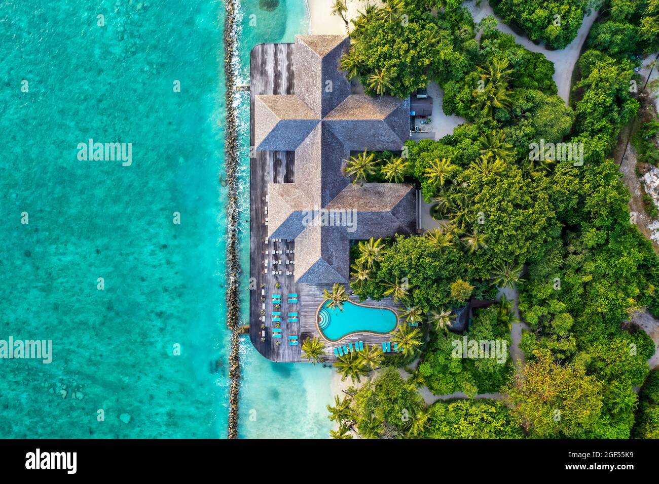 Maldives, Lhaviyani Atoll, Kuredu, Aerial view of coastal tourist resort with outdoor swimming pool Stock Photo