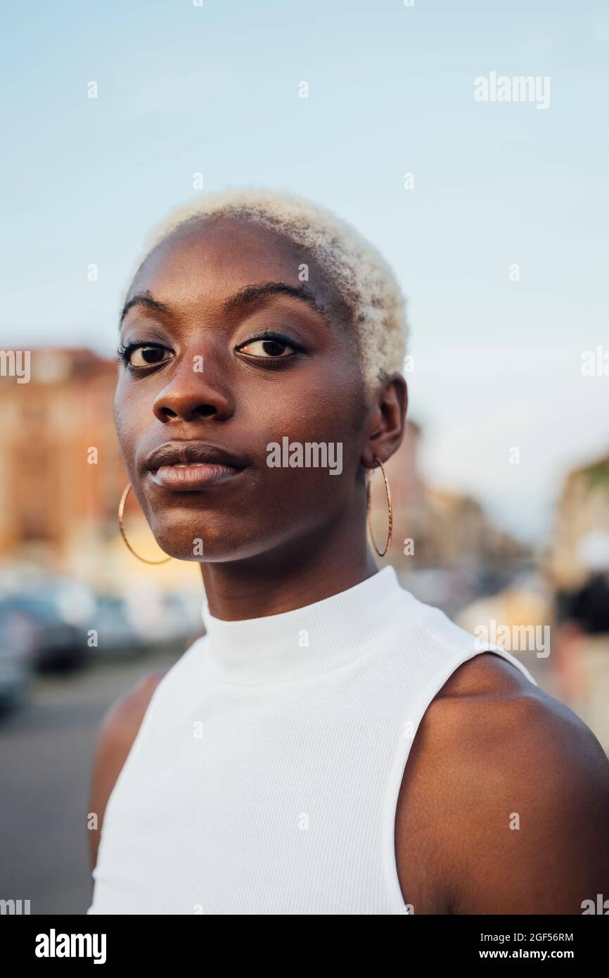 Young woman with short white hair staring Stock Photo