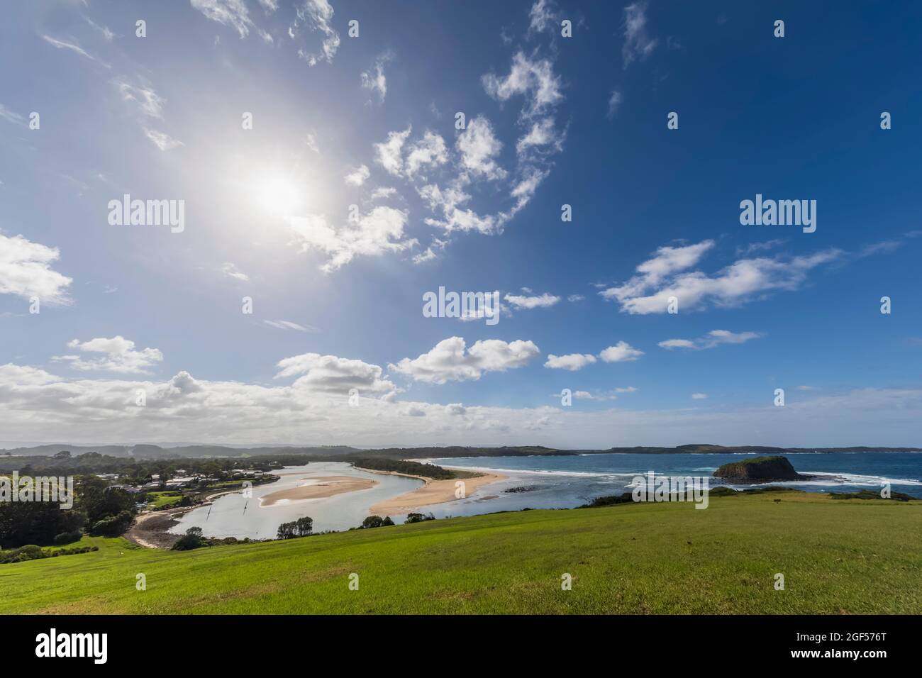 Summer sun shining over bank of Minnamurra River Stock Photo