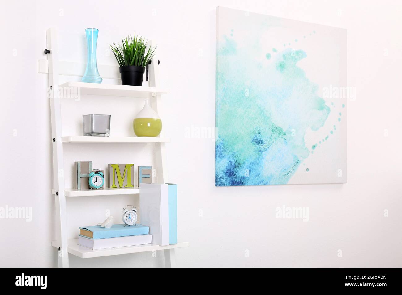 White bookcase against wall with bright picture in the room Stock Photo Alamy