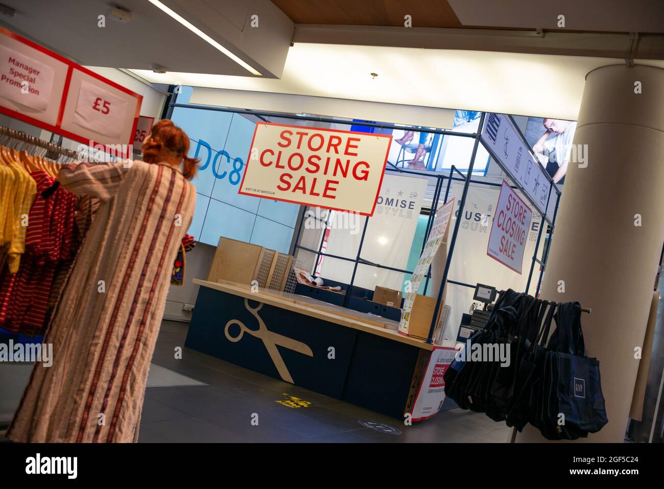 Store Closing Sale sign and customer at GAP London Oxford Street Flagship Store near to Bond