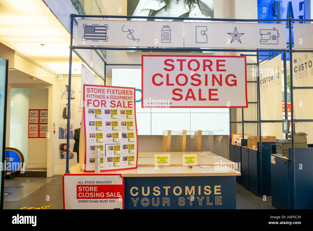 Store Closing Sale signs showing fixtures and fittings for sale at GAP London Oxford Street Flagship Store near to Bond Street - 17 August 2021 Stock Photo