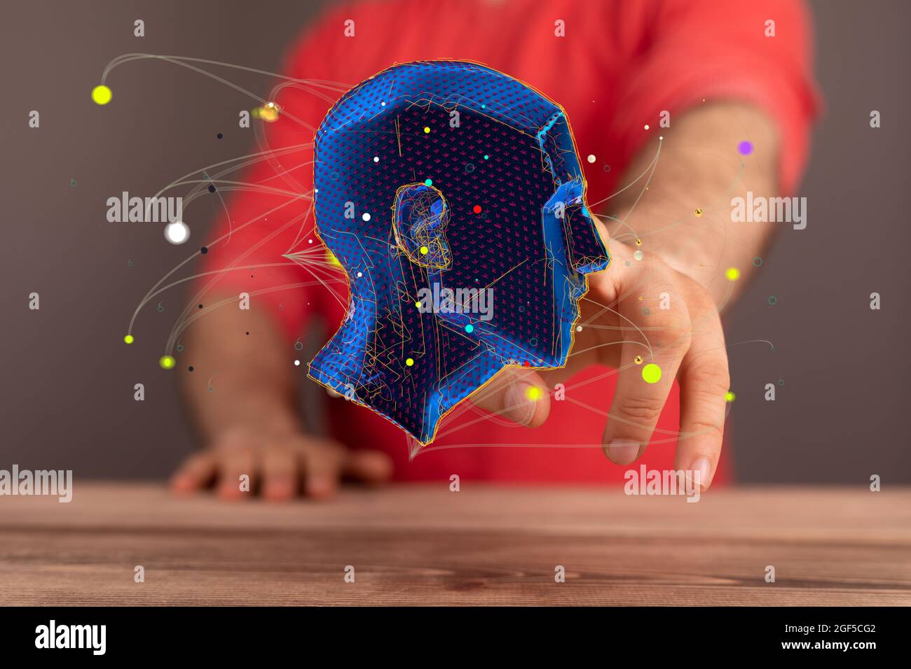 Man holding an abstract polygonal 3D human head Stock Photo