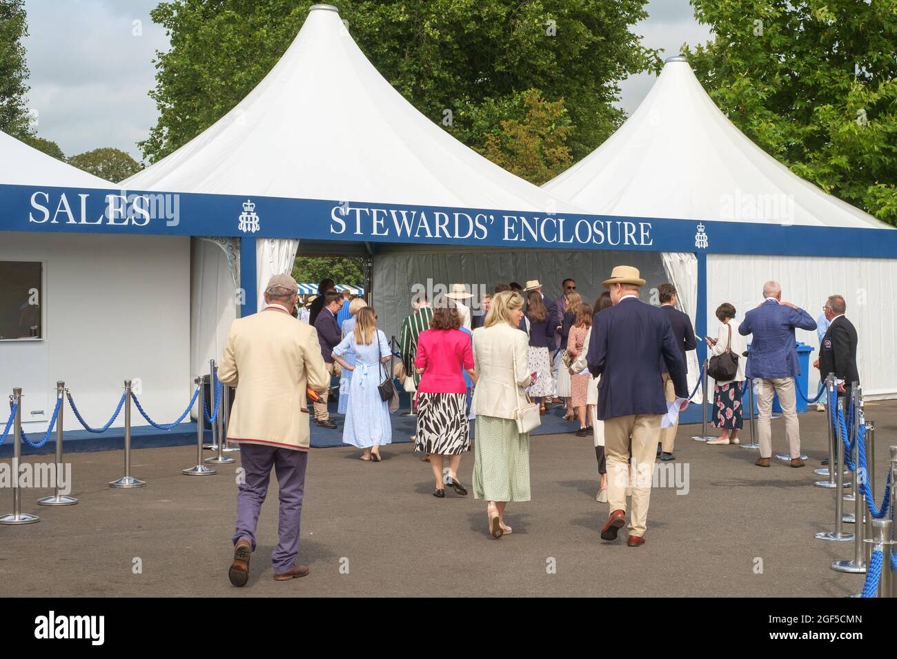 Smartly dressed spectators enter the Stewards Enclosure at Henley Royal Regatta 2021 on the River Thames Stock Photo