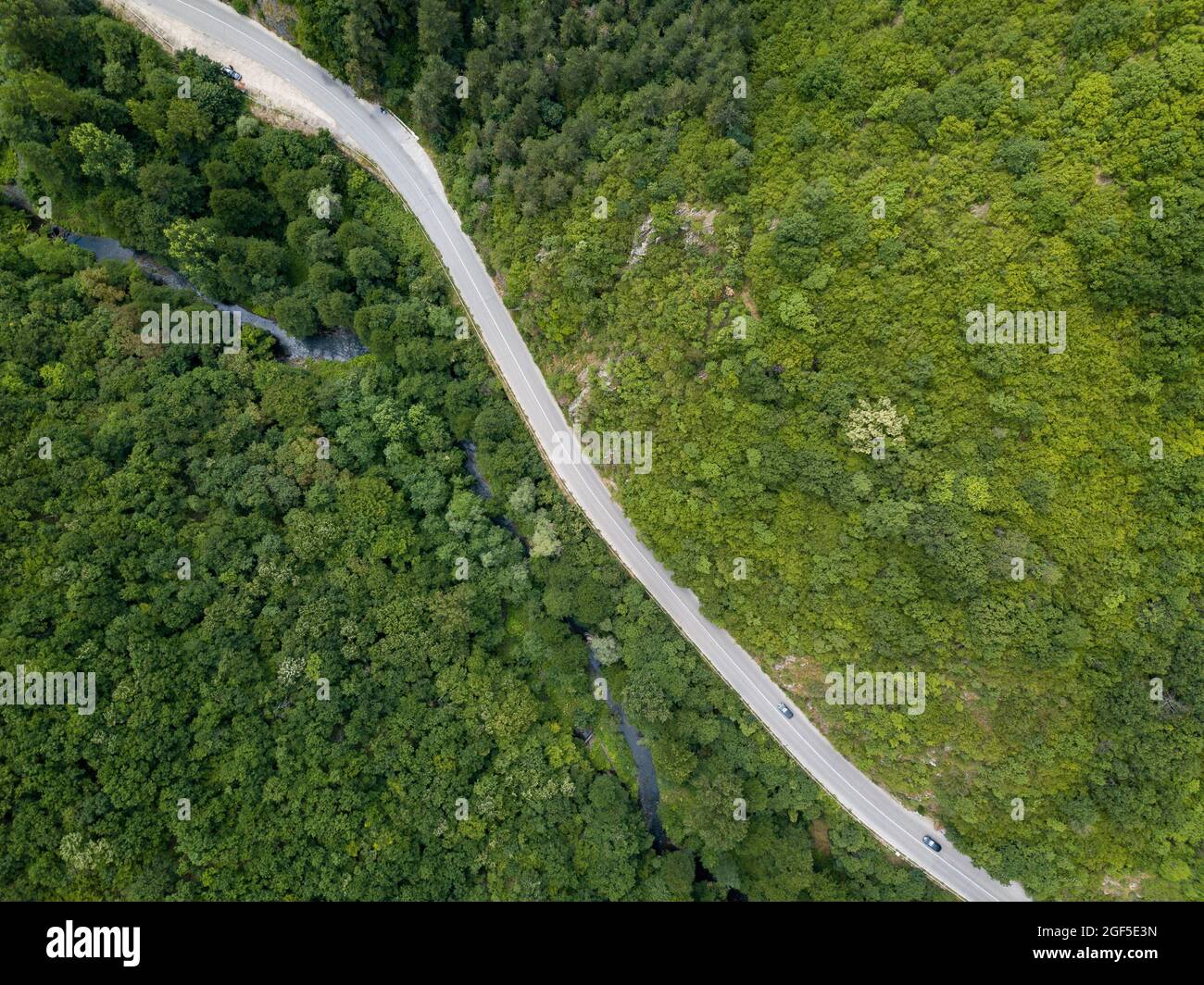 Aerial view of a country road surrounded by lush green forest Stock ...
